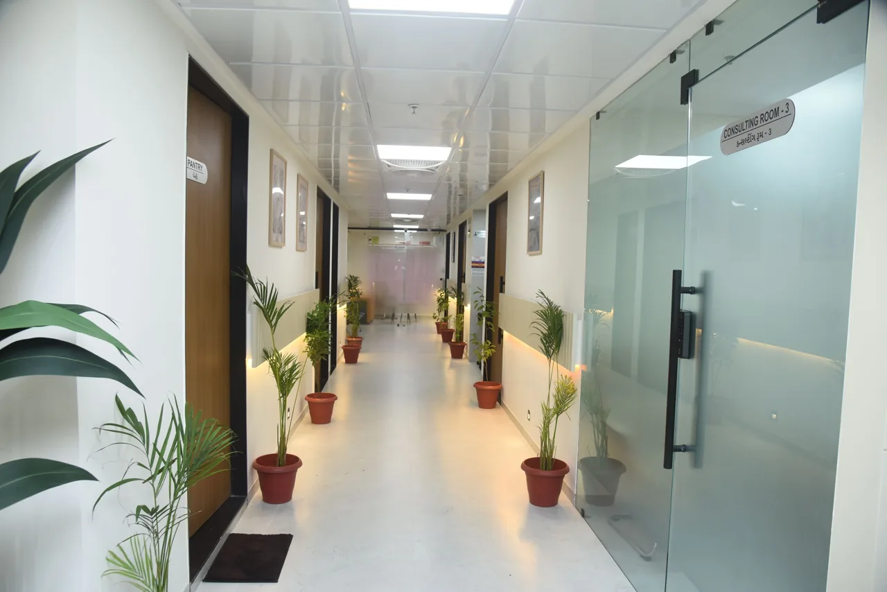 Hospital corridor with glass doors leading to consultation rooms