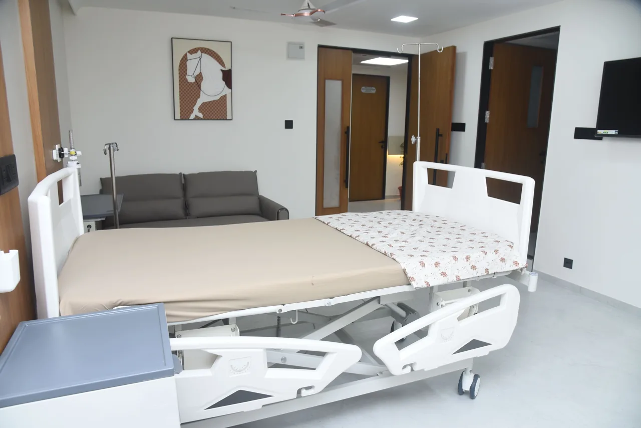 Patient bed with a sofa for visitors in the room