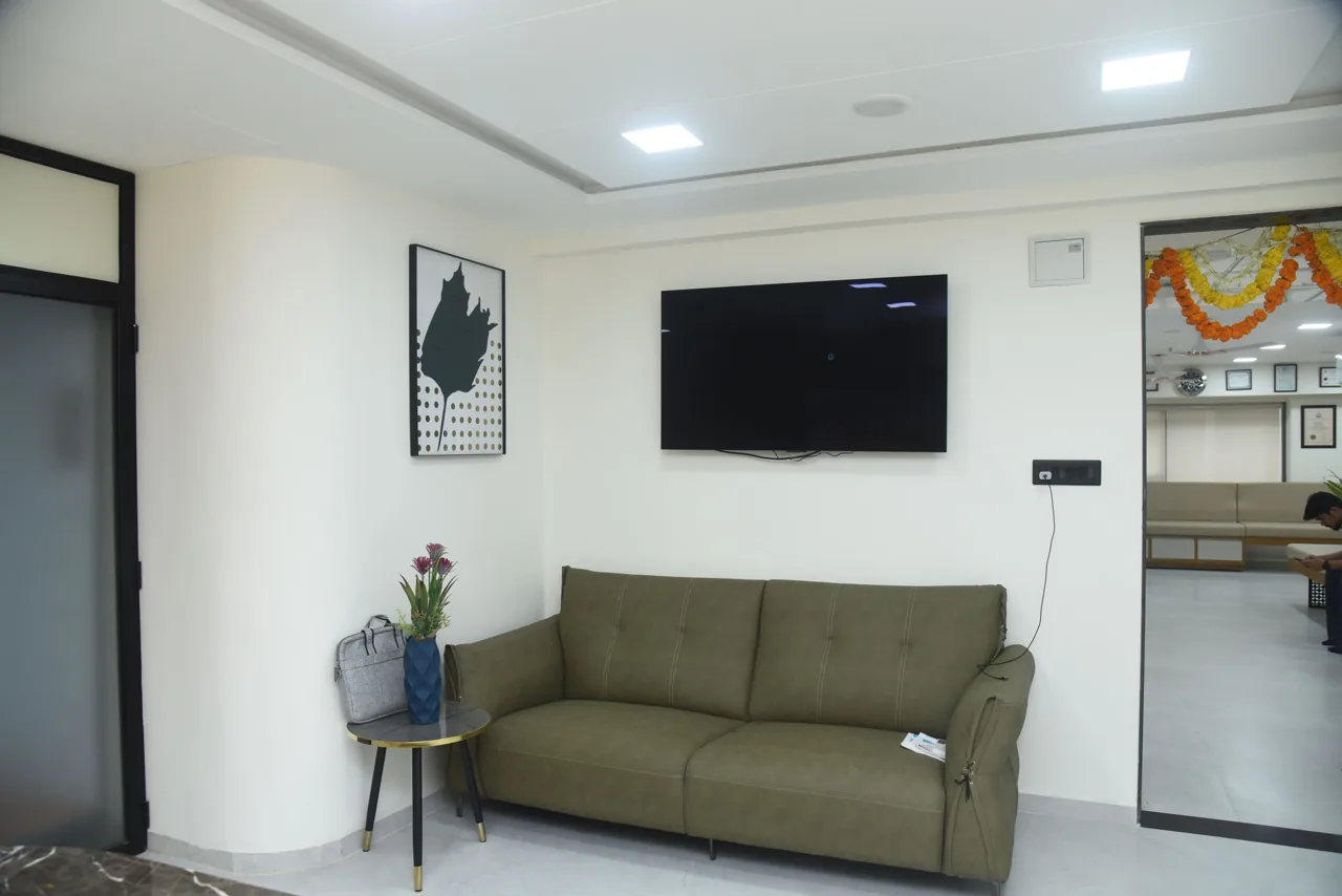 Sofa and wall-mounted television in a hospital seating area